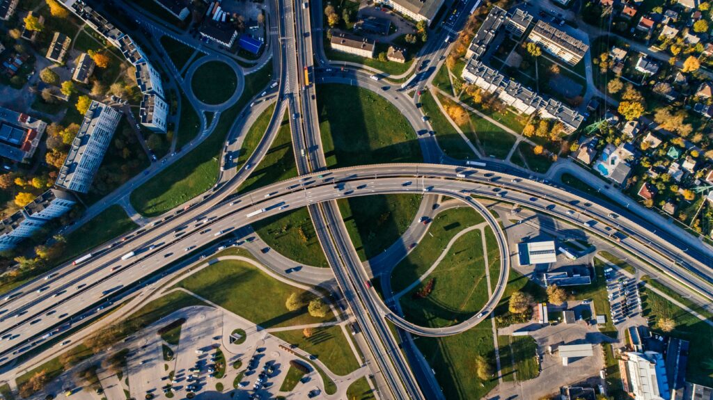 Aerial view of a complex highway interchange showcasing seamless connectivity and transport optimisation, symbolising collaboration and efficiency in freight management.